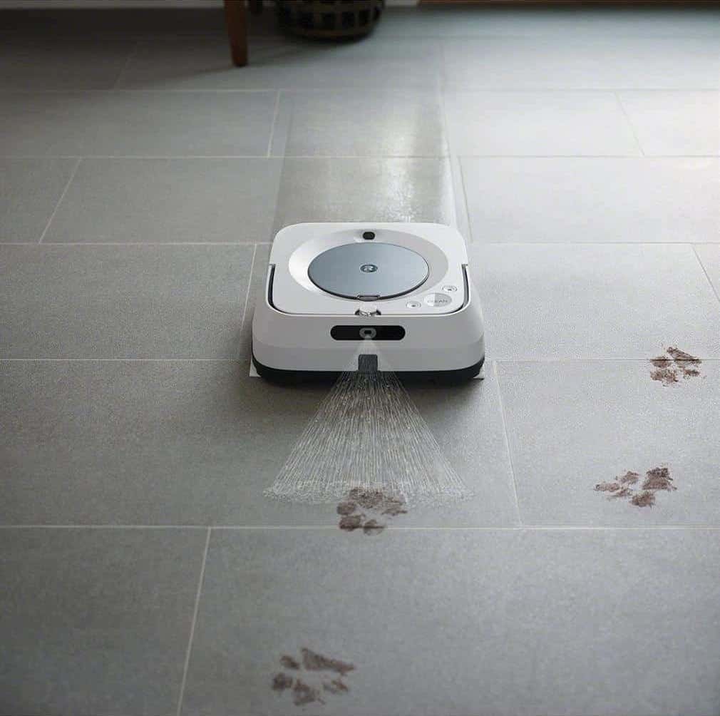 A braava jet m6 robot vacuum with paw prints on the floor is cleverly designed to efficiently clean your home.