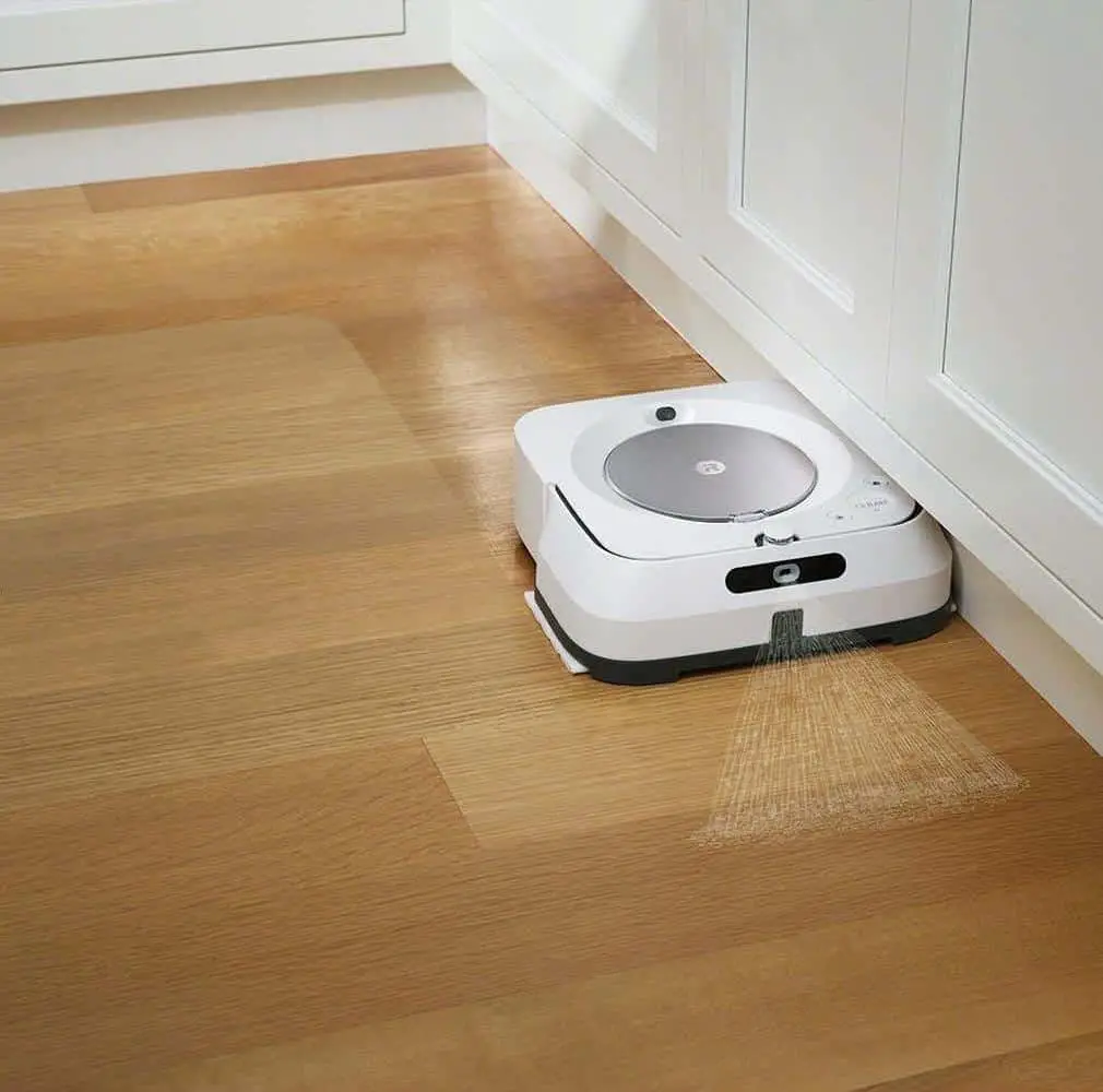 The Braava Jet M6, a robotic vacuum cleaner, precisely navigates the floor of a kitchen.