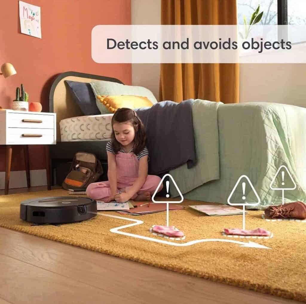 A child is playing with a Roomba Combo J9+ robot on the floor.